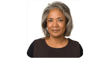 Lisa a working woman smiling and sharing her SharpEar experience with clearer hearing during meetings and daily life